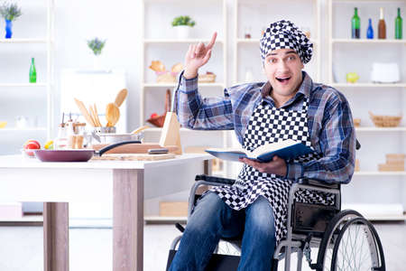 Young man cook with book of food recipesの写真素材