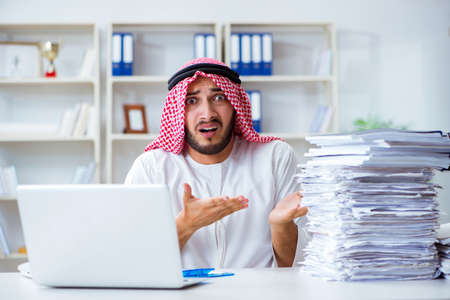 Arab businessman working in the office doing paperwork with a piの写真素材