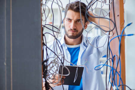 Electrician trying to untangle wires in repair conceptの写真素材