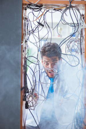 Electrician trying to untangle wires in repair concept