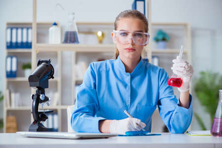 Female scientist researcher conducting an experiment in a labora