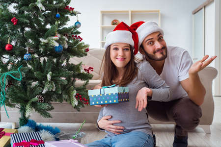 Young family expecting child baby celebrating christmasの写真素材