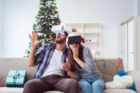 Happy family using virtual reality VR glasses during christmas