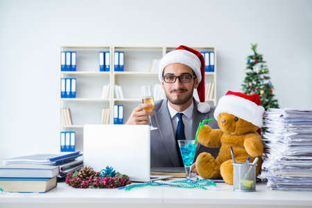 Young businessman celebrating christmas in the officeの写真素材