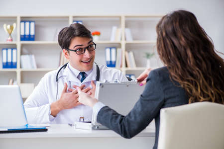 Young doctor in medical insurance fraud conceptの写真素材