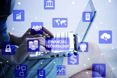 Hands working on laptop in financial technology fintech conceptの写真素材