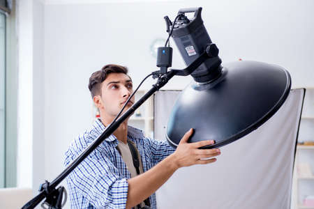 Young photographer working in photo studio