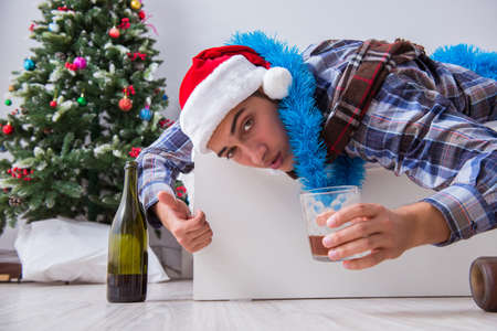 Man suffering hangover after christmas partyの写真素材