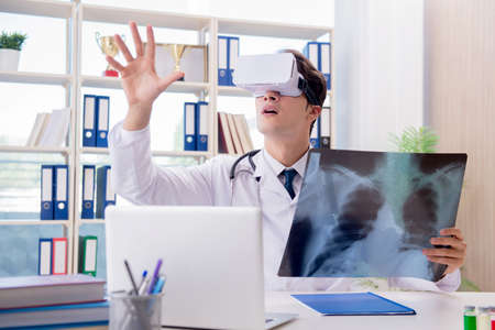 Doctor working with virtual VR reality glassesの写真素材