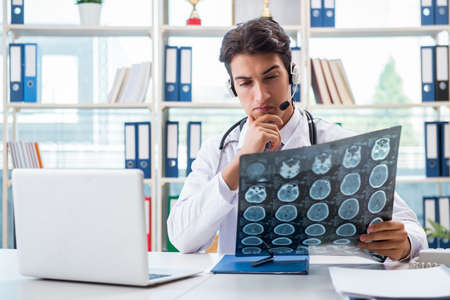 Young male doctor in telehealth concept