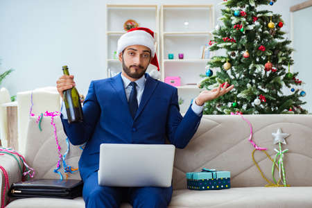 Businessman working at home during christmasの写真素材