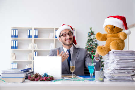 Young businessman celebrating christmas in the officeの写真素材