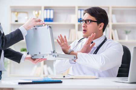 Young doctor in medical insurance fraud conceptの写真素材