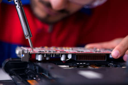 Repairman working in technical support fixing computer laptop troubleshooting