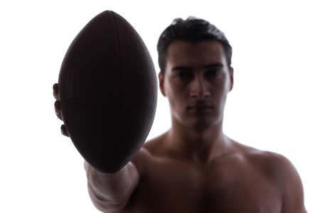 Ripped young man with american football isolated on white