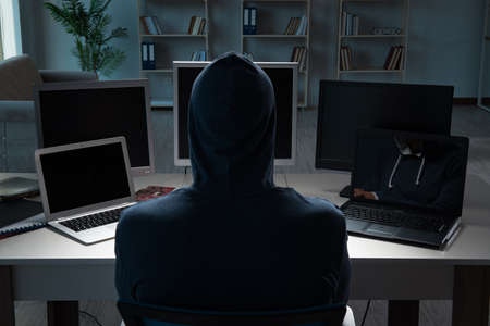 Hacker hacking computer at night