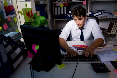 Man businessman working late hours in the office