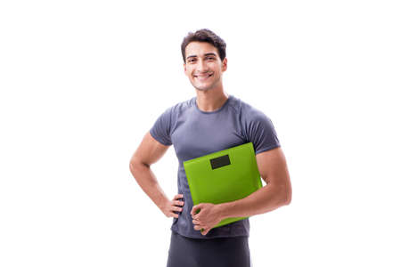Man with scales in sports and health concept isolated on whiteの写真素材
