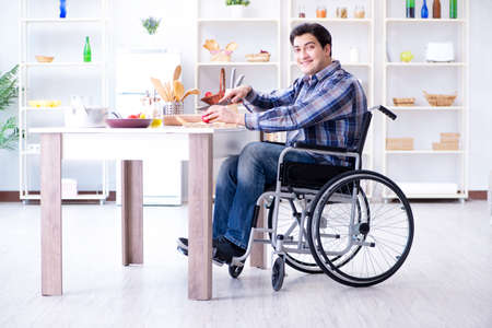 Young disabled husband preparing food saladの写真素材