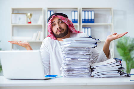 Arab businessman working in the office doing paperwork with a piの写真素材