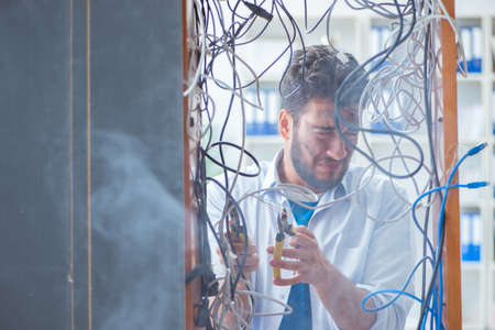 Electrician trying to untangle wires in repair concept