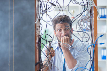 Electrician trying to untangle wires in repair concept