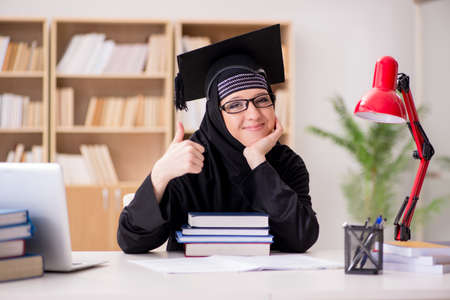 Muslim girl in hijab studying preparing for examsの写真素材
