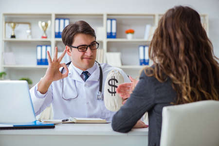 Young doctor in medical insurance fraud conceptの写真素材