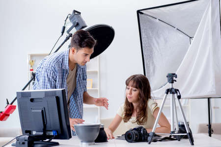Young photographer working in photo studioの写真素材