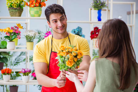 Florist selling flowers in a flower shopの写真素材