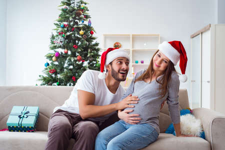 Young family expecting child baby celebrating christmasの写真素材