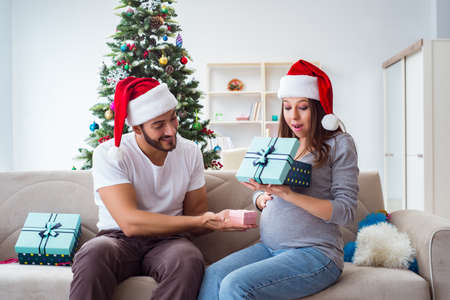 Young family expecting child baby celebrating christmasの写真素材