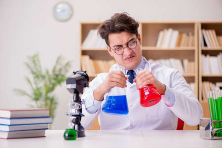 Mad crazy scientist doctor doing experiments in a laboratory