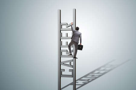 Businessman in career ladder conceptの写真素材