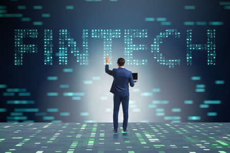 Businessman pressing buttons in fintech conceptの写真素材