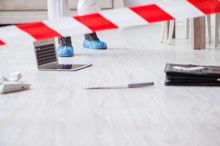 Forensic expert at crime scene doing investigationの写真素材