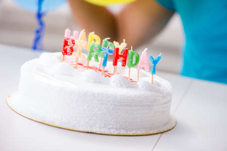 Young man celebrating birthday alone at home