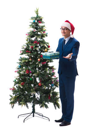 Businessman decorating christmas tree isolated on whiteの写真素材