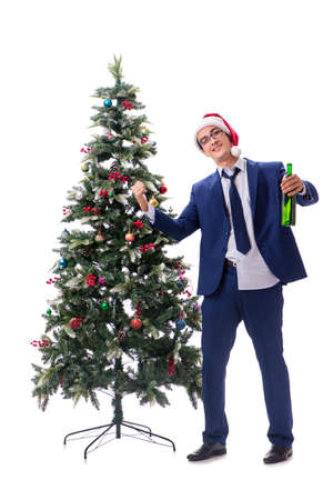Businessman decorating christmas tree isolated on whiteの写真素材
