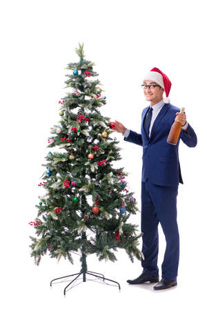Businessman decorating christmas tree isolated on whiteの写真素材