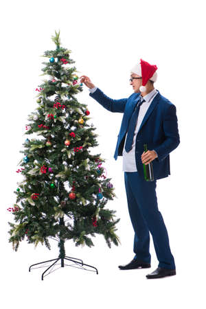 Businessman decorating christmas tree isolated on whiteの写真素材