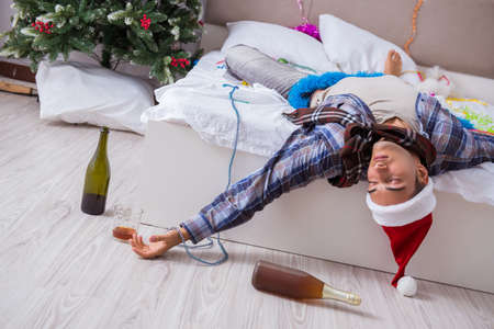 Man suffering hangover after christmas partyの写真素材