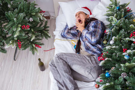 Man suffering hangover after christmas partyの写真素材