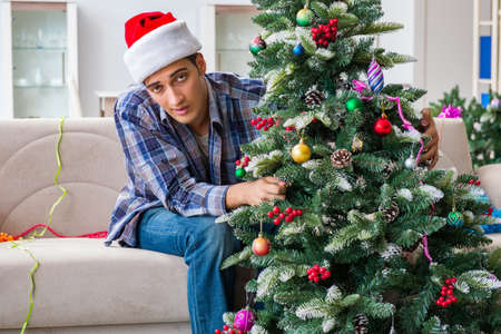Man having hangover after christmas partyの写真素材