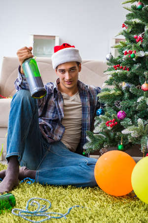 Man having hangover after christmas partyの写真素材