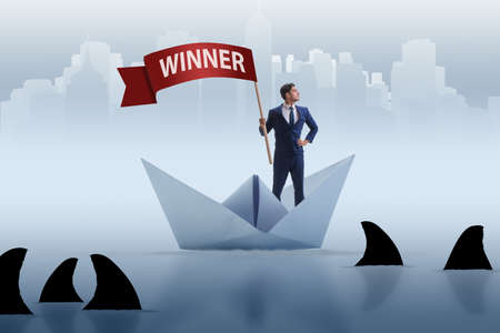 Businessman riding paper boat ship in winning conceptの写真素材