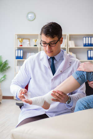 Doctor and patient during check-up for injury in hospitalの写真素材