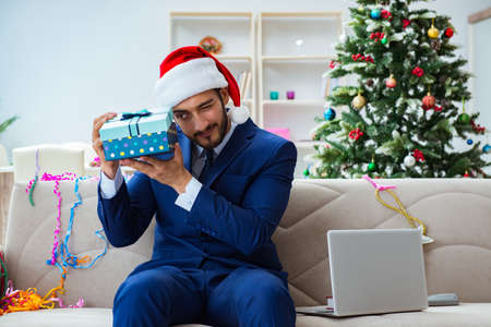 Businessman working at home during christmasの写真素材