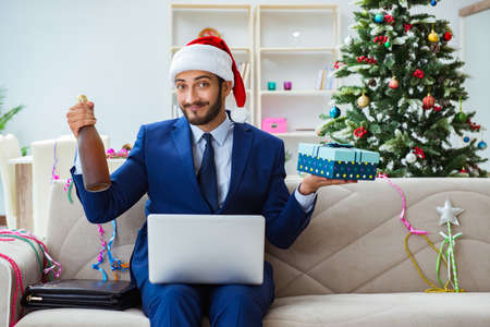 Businessman working at home during christmasの写真素材