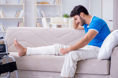 Injured young man recovering at homeの写真素材